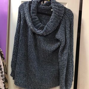 Beautiful woman’s off  the shoulder blue sweater
